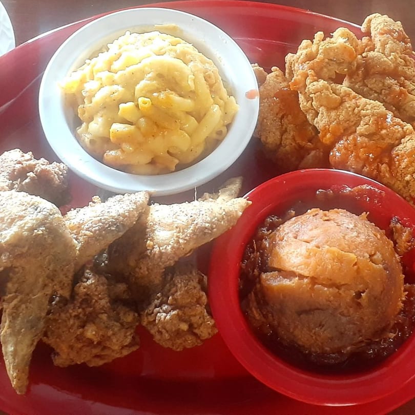 Aunt Berta's Kitchen soul food platter with fried chicken, macaroni and cheese, and candied yams.